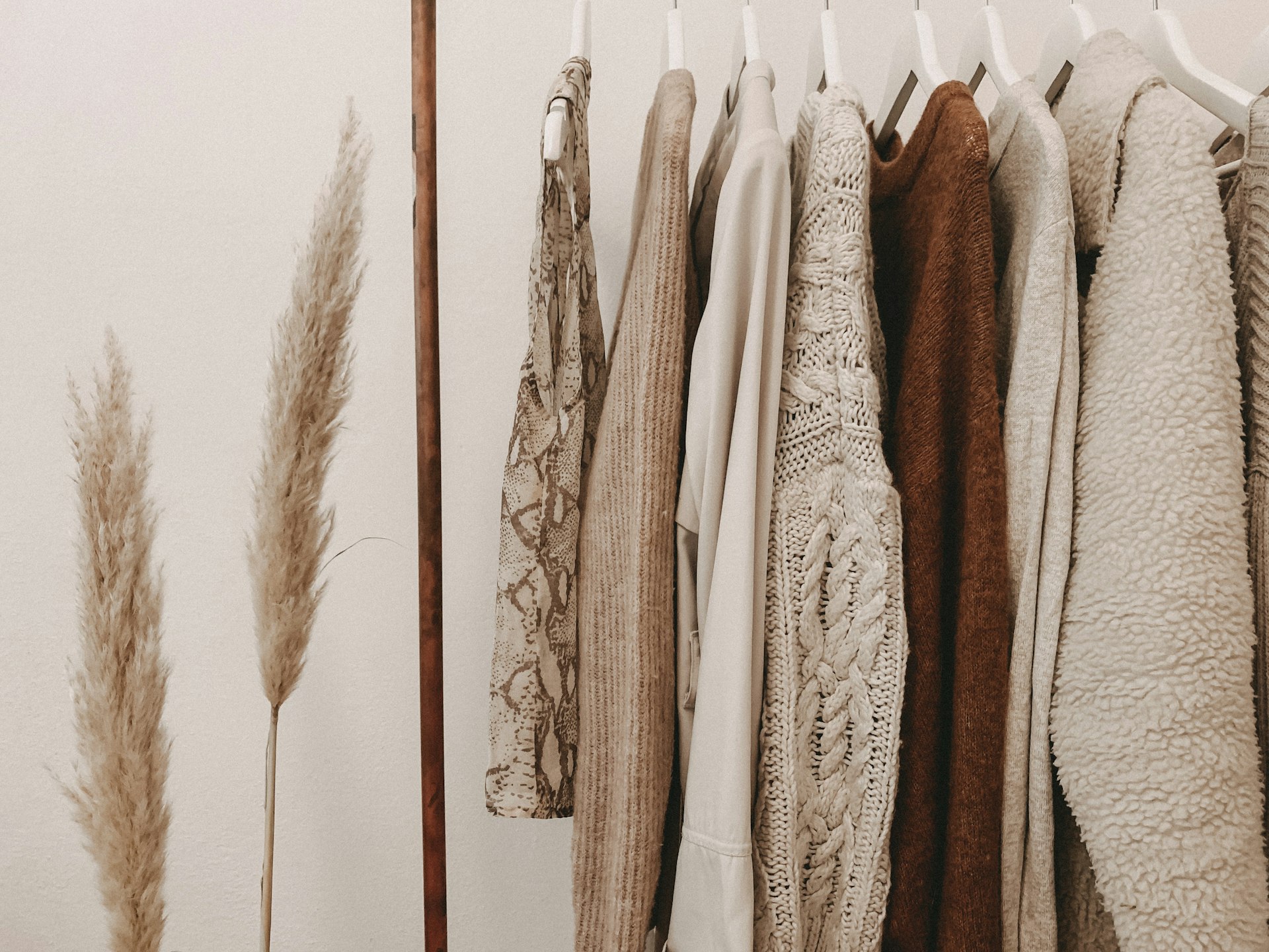 Vintage and streetwear apparel curation on wooden rack in modern studio